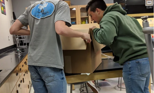 Students opening Box of tools to Study the Colorado River provided by the Student Research Foundation