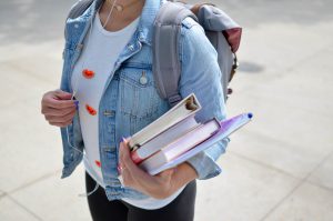 Student Carrying Books - Is America’s Love Affair with College Fading Away