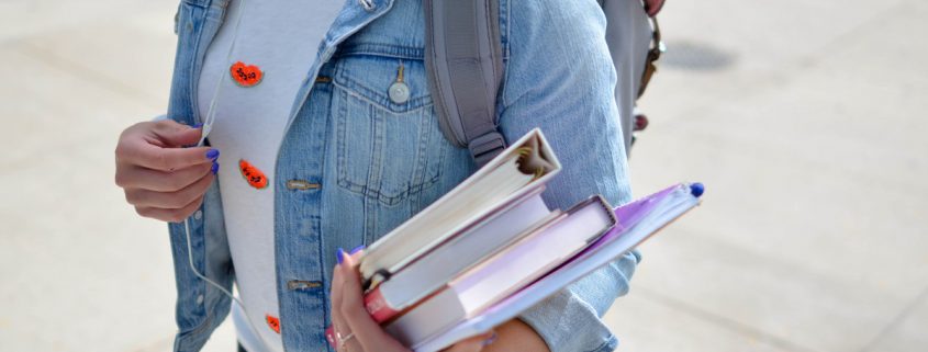 Student Carrying Books - Is America’s Love Affair with College Fading Away